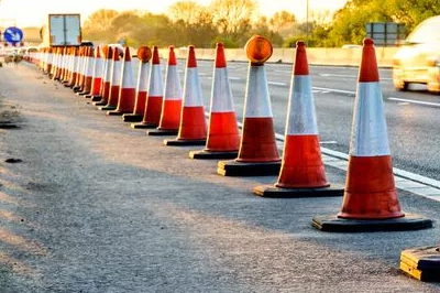 A row of traffic cones on a road